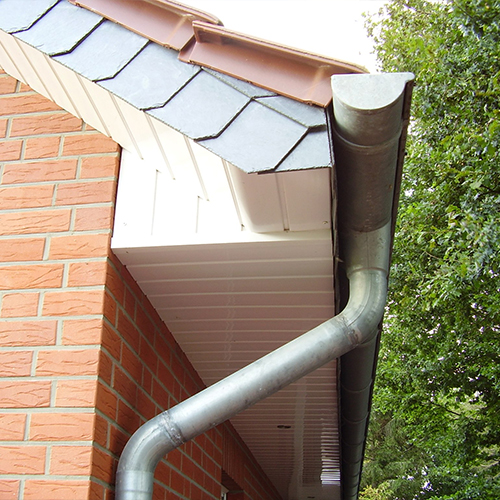 Half-round gutters on a light bright home.